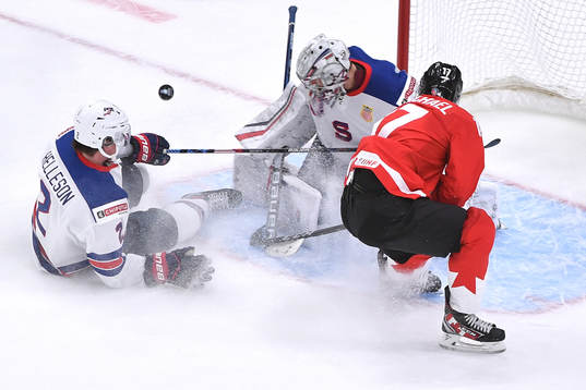 Connor McMichael of Canada crashes the net as the puck