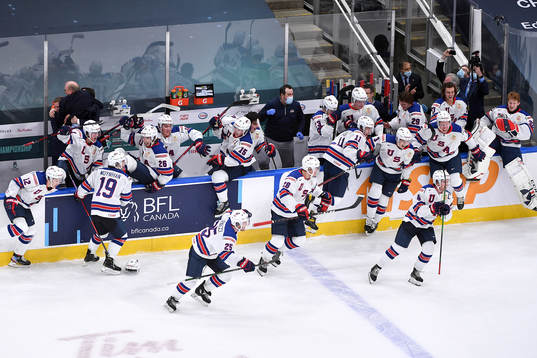 Team USA jumps off their bench to celebrate their victory