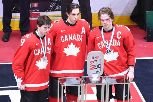 Connor McMichael, Dylan Cozens and Bowen Byram of Canada