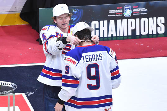 Cam York of USA presents his teammate Trevor Zegras with