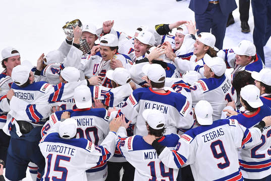 Team USA celebrates with the championship trophy