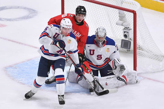 Dylan Holloway of Canada and Jackson LaCombe of USA battle