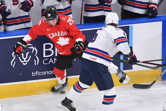 Jackson LaCombe of USA collides with Dawson Mercer of Canada