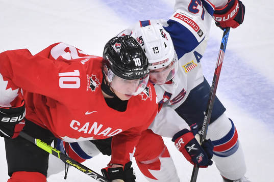 Dylan Holloway of Canada and Cole Caufield of USA battle
