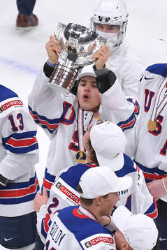 Alex Turcotte of USA hoists the first place trophy