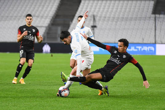 Nemanja RADONJIC of Marseille and Sofiane ALAKOUCH of Nimes