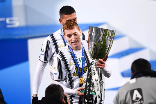 Dejan Kulusevski of Juventus celebrates with the trophy