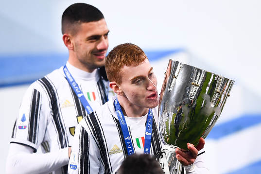Dejan Kulusevski of Juventus celebrates with the trophy