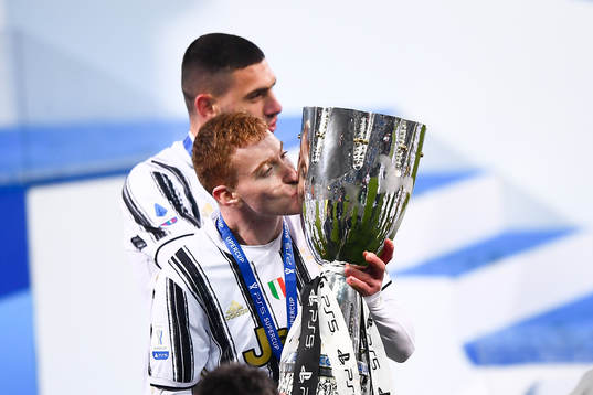 Dejan Kulusevski of Juventus celebrates with the trophy