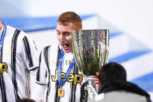 Dejan Kulusevski of Juventus celebrates with the trophy