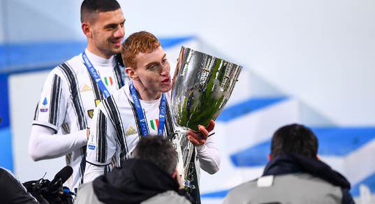 Dejan Kulusevski of Juventus celebrates with the trophy