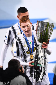 Dejan Kulusevski of Juventus celebrates with the trophy