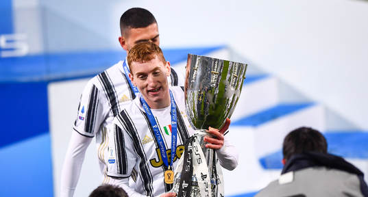 Dejan Kulusevski of Juventus celebrates with the trophy