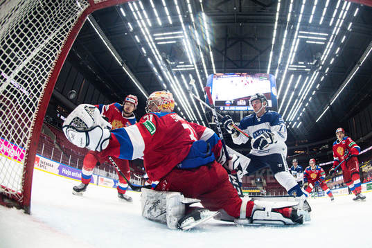 Juuso Puustinen of Finland and goalkeeper Alexander Samonov
