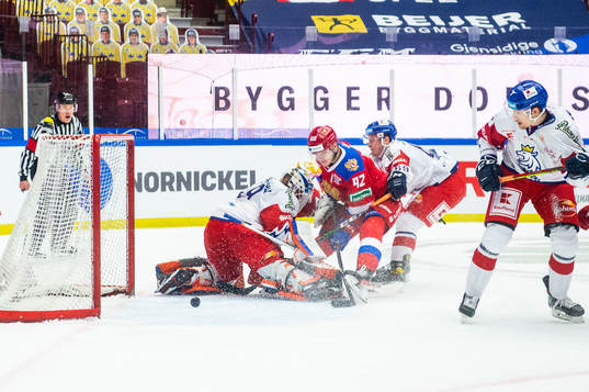 Vasily Podkolzin of Russia scores behind goalkeeper Dominik