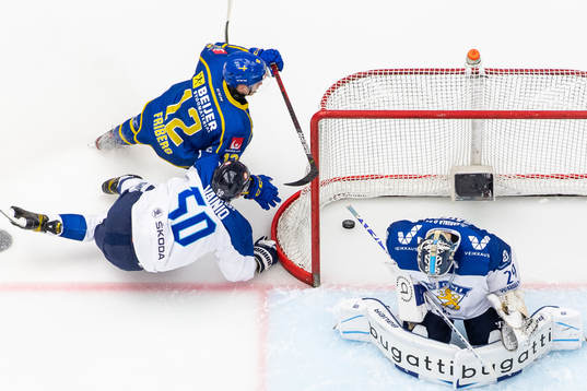 Max Friberg of Sweden scores 1-0 behind goalkeeper Harri