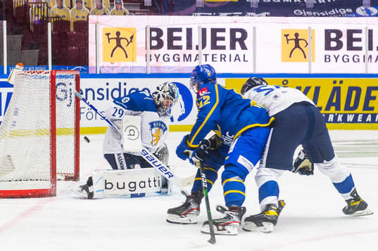 Max Friberg of Sweden scores 1-0 behind goalkeeper Harri
