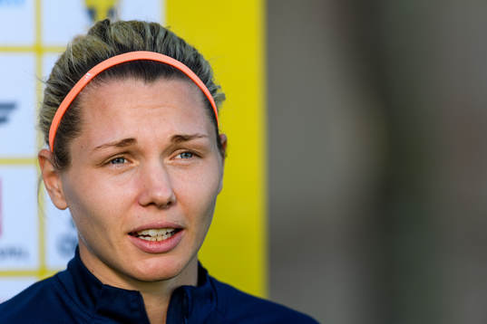 Goalkeeper Jennifer Falk is interviewed by the media