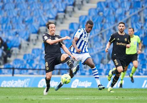 Alexander Isak of Real Sociedad duels for the ball with