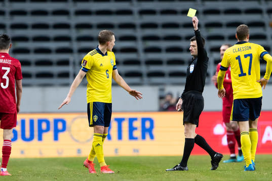 Ludwig Augustinsson of Sweden is shown a yellow card
