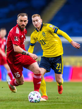 Giorgi Aburjania of Georgia and Dejan Kulusevski of Sweden