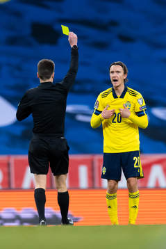 Kristoffer Olsson of Sweden is shown a yellow card