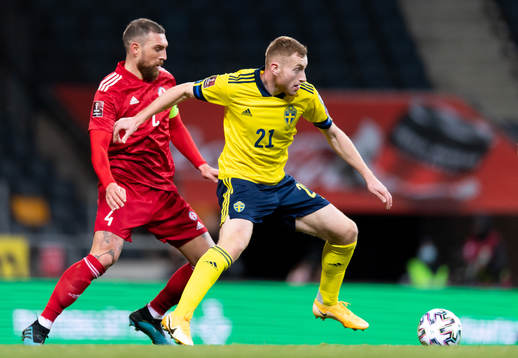 Guram Kashia of Georgia and Dejan Kulusevski of Sweden
