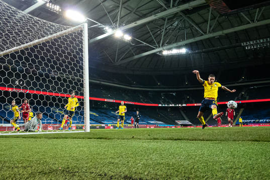 Mikael Lustig of Sweden stretches for the ball