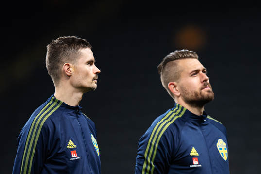Mikael Lustig and goalkeeper Kristoffer Nordfeldt of Sweden