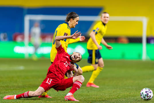Kristoffer Olsson of Sweden competes for the ball with