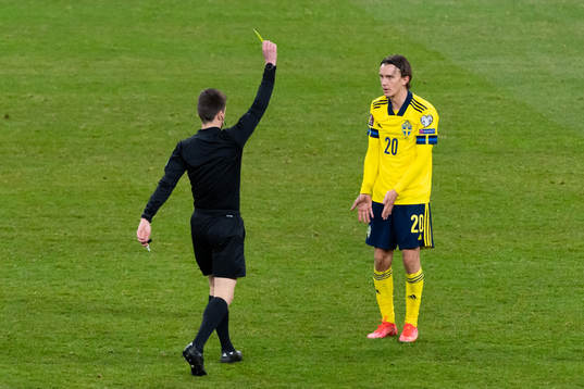 Kristoffer Olsson of Sweden is shown a yellow card
