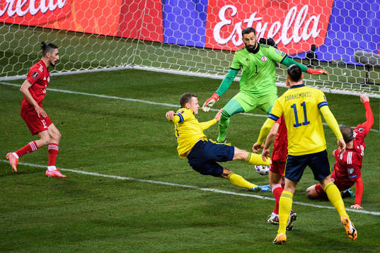 Viktor Claesson of Sweden scores the 1-0 goal behind