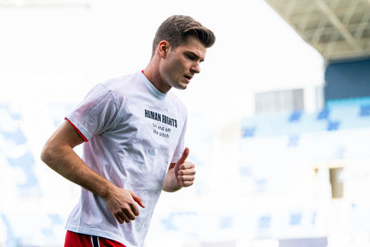Alexander Sørloth of Norway warms up wearing a t-shirt