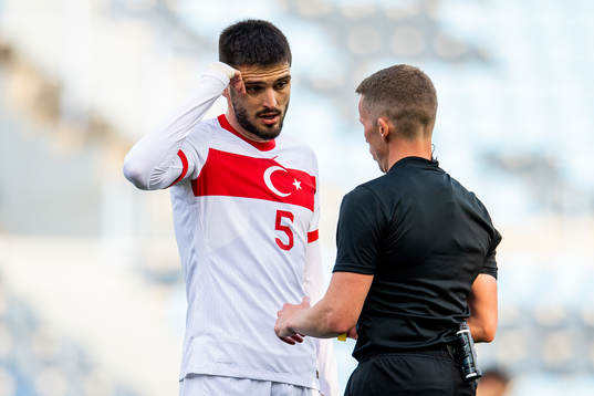 Okay Yokuslu of Turkey talks to referee Alejandro Hernandez