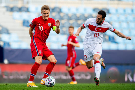 Martin Ødegaard of Norway and Hakan Çalhanoglu of Turkey