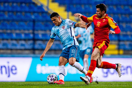Mohamed Elyounoussi of Norway and Vladimir Jovovic of