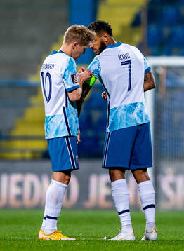 Martin Ødegaard of Norway gives the captain’s armband to