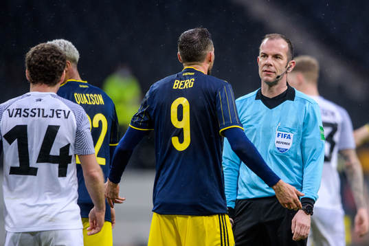 Marcus Berg of Sweden in a discussion with referee Marco