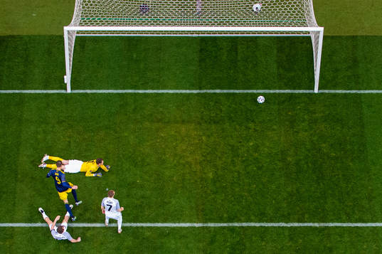 Marcus Berg of Sweden scores 1-0 beyond goalkeeper Matvei