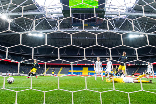 Marcus Berg of Sweden scores 1-0 behind goalkeeper Matvei
