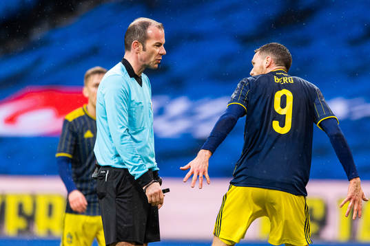 Referee Marco Fritz and Marcus Berg of Sweden