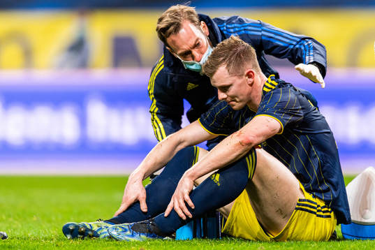 Emil Krafth of Sweden receives medical attention
