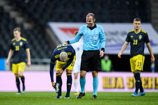 Robin Quaison of Sweden and referee Marco Fritz