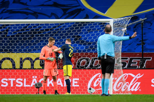 goalkeeper Karl-Johan Johnsson receives the captains