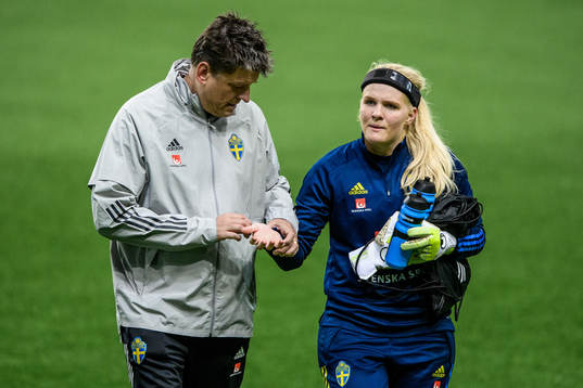 goalkeeper Emma Holmgren of Sweden receives medical