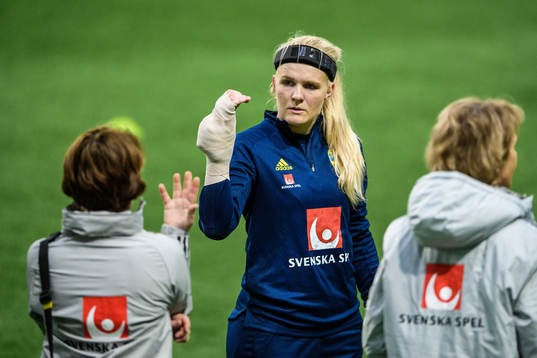goalkeeper Emma Holmgren of Sweden receives medical