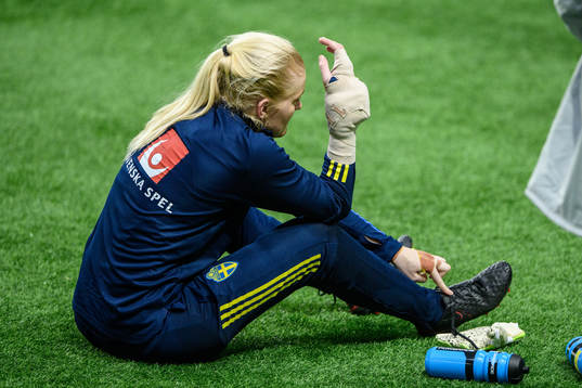 goalkeeper Emma Holmgren of Sweden receives medical