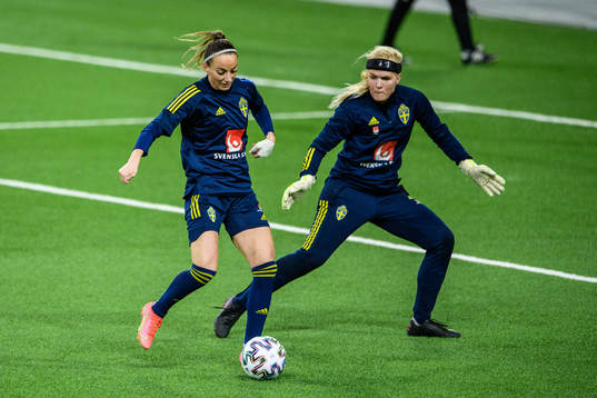Kosovare Asllani and goalkeeper Emma Holmgren of Sweden