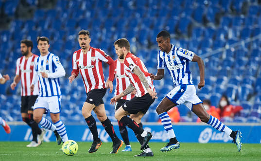 Alexander Isak of Real Sociedad duels for the ball with