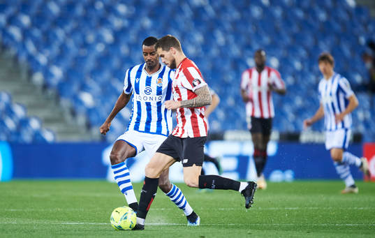 Alexander Isak of Real Sociedad duels for the ball with